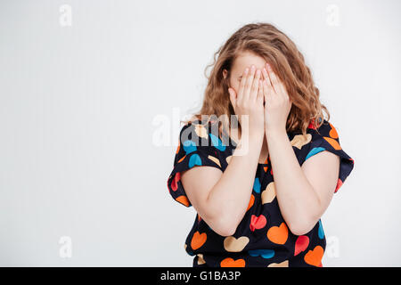 Woman covering her face with palms isolated on a white background Stock Photo