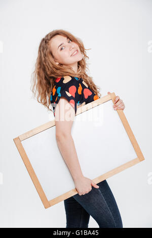 Happy woman holding blank board isolated on a white background Stock Photo