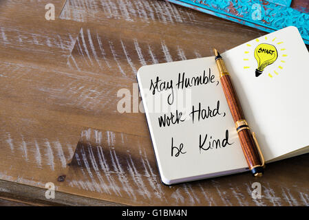 Handwritten text Stay humble, work hard, be kind with fountain pen on notebook. Concept image with copy space available. Stock Photo