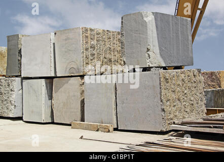 Huge Indian granite blocks stacked in stone processing factory for cutting and polishing into flooring slabs used in buildings Stock Photo