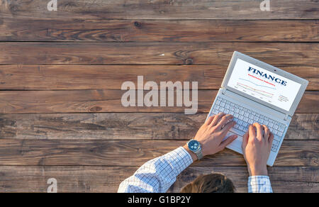 Rough Empty Natural Wood Table and Businessman Working on Computer Stock Photo