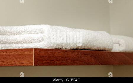 White towels on shelf in home or hotel for service Stock Photo