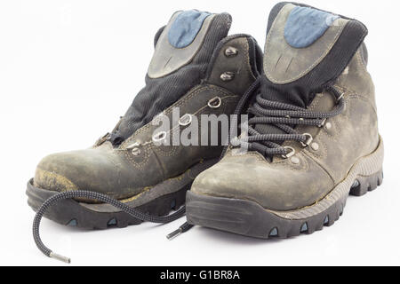 Old weathered and broken hiking boots isolated on white background Stock Photo