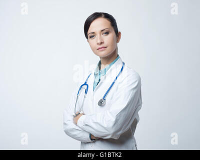 Confident smiling female doctor posing with lab coat and stethoscope. Stock Photo
