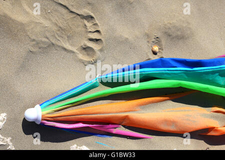 broken abandoned parasol at the sandy beach after summer holidays Stock Photo