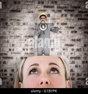 Composite image of architect with hard hat shouting with a megaphone Stock Photo