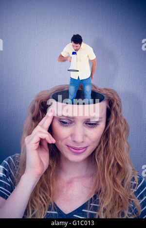 Composite image of young man shouting through megaphone Stock Photo