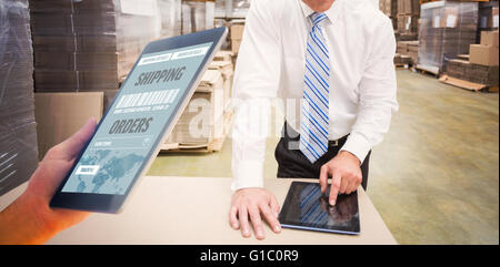Composite image of man using tablet pc Stock Photo