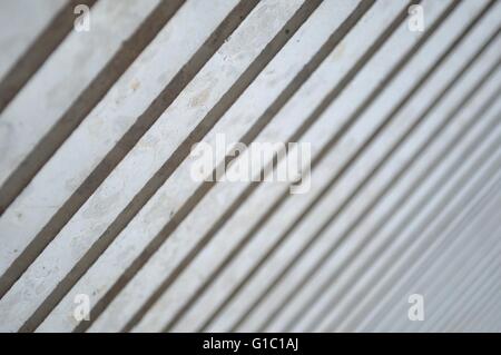 Light and Shadows on modern columns in diagonal as abstract art. Selective focus. Stock Photo