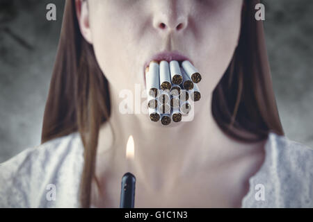 Composite image of woman lighting many cigarettes in mouth Stock Photo