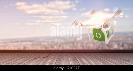 Composite image of digital image of a drone holding a cube Stock Photo