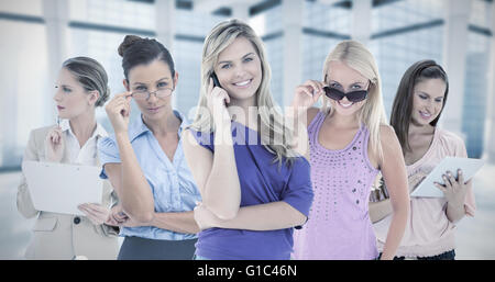 Composite image of happy blonde woman using her cellphone Stock Photo