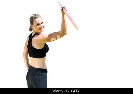 Rear view of sporty woman holding a javelin Stock Photo