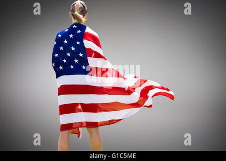 Composite image of rear view of sporty woman holding an american flag Stock Photo