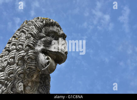 Ferocious Lion, detail of an ancient lion statue, in the Lucca medieval walls gardens Stock Photo