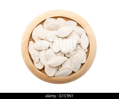 Pumpkin seeds in wooden dish isolated on white background, Save clipping path. Stock Photo