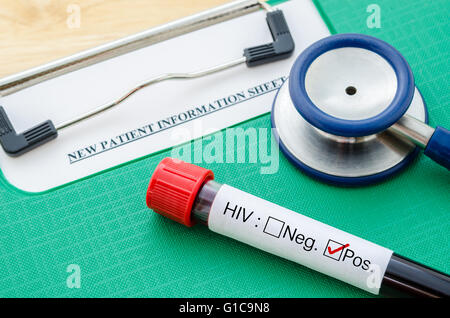 Sample blood tube with HIV test label on HIV infection and stethoscope with new patient record sheet. Stock Photo