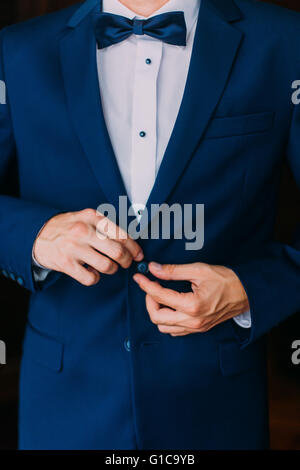 a man in a blue suit stud buttons Stock Photo - Alamy