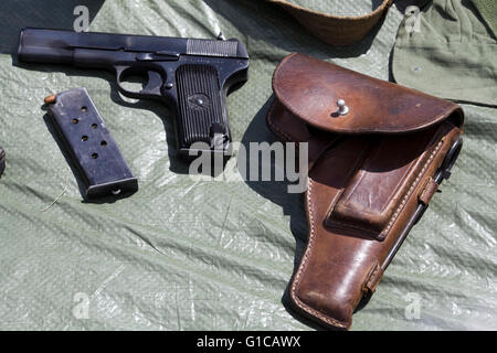 M1911A1 single-action, semi-automatic, magazine-fed, recoil-operated pistol and leather case Stock Photo