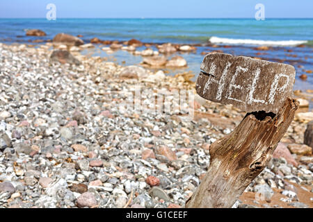 Help word written on an old wooden board, conceptual picture, shallow depth of field. Stock Photo