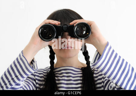 young female sailor looking through binoculars Stock Photo