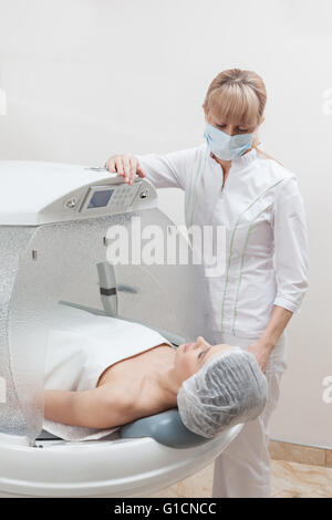 Woman in capsule at spa salon Stock Photo