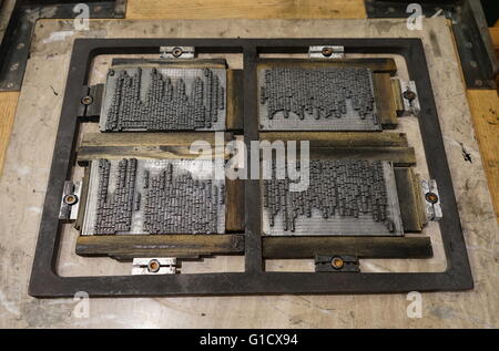 Metal plate with letters set to print a page from a reconstruction of a 16th Century printing press. Stock Photo