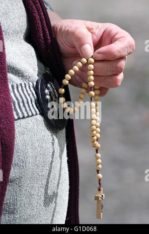 Hand-carved Roman Catholic rosary beads. Woman praying The Mystery of the Holy Rosary. La Roche-sur-Foron. France. Stock Photo