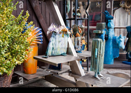 Wooden carved funny art figures in shop exterior in Kazimierz Dolny, Poland, Europe, bohemian tourist travel destination, sights Stock Photo