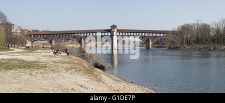 Pavia, Italy - March 8, 2015: Covered bridge over the river Ticino. Very quaint, has five arches and is completely covered with Stock Photo