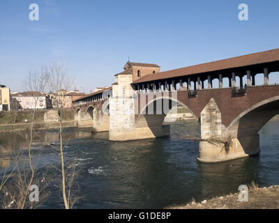 Pavia, Italy - March 8, 2015: Covered bridge over the river Ticino. Very quaint, has five arches and is completely covered with Stock Photo