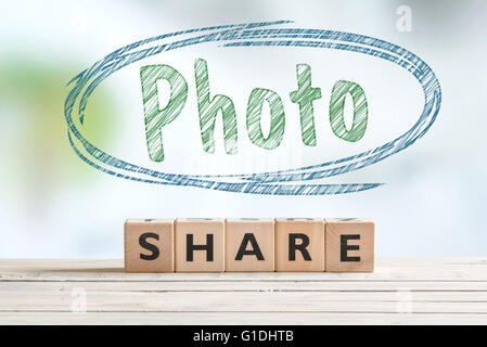 Share photo sign on a wooden desk Stock Photo