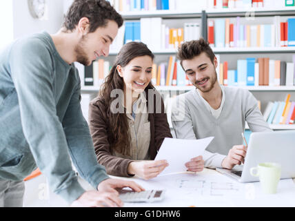 College students working together on a project, education and learning concept Stock Photo