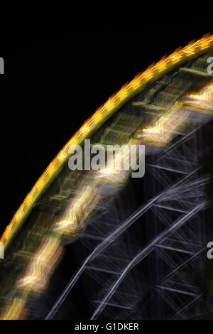Ferris wheel in the night with motion blur. Stock Photo