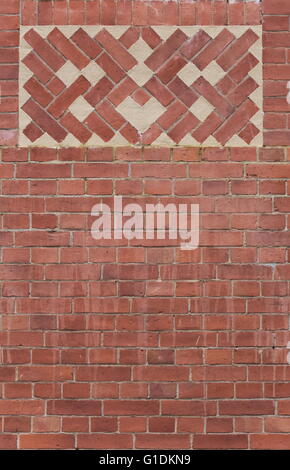 Texture of red brick wall with plastered ornaments. Stock Photo