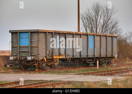 Goods wagon standing on rails in Germany. Stock Photo