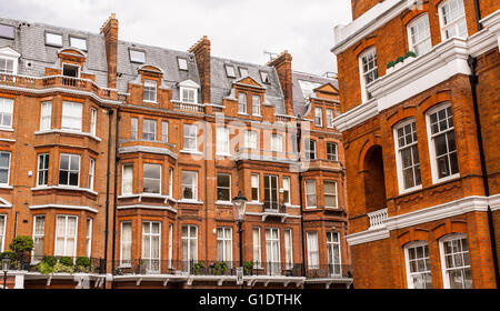 Facade of opulent British Victorian Edwardian terraced flat in red bricks in Chelsea, London. Stock Photo