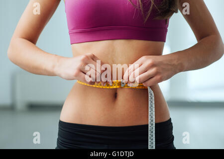 Young Girl In Bras Measures Belly With Tape Stock Photo, Picture and  Royalty Free Image. Image 195431754.