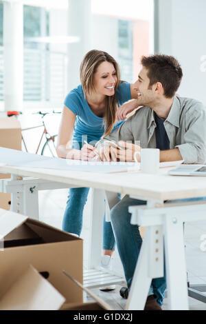 Romantic loving couple planning and designing their new house, they are staring at each other's eyes Stock Photo