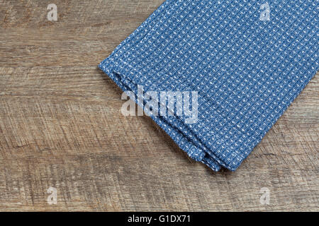 Blue tea towel on walnut wooden background. Top view with copy space. Stock Photo