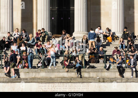 Students sitting on the steps of the Portico and Quad at University College London (UCL), Bloomsbury, London, England, UK Stock Photo