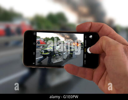 Onlookers take picture with a mobile phone camera, of an accident, symbolic image, photomontage, photo composition, Onlookers take picture with a mobile phone camera, of an accident, symbolic image, photomontage, photo composition,
