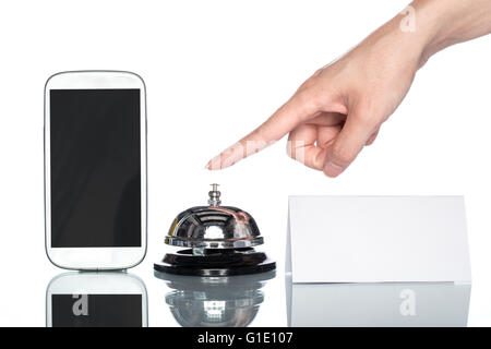 cell phone and Service bell with human hand on white background Stock Photo
