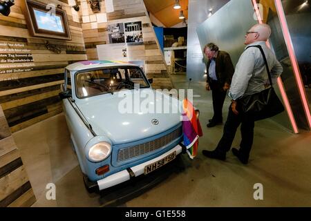 Hamburg, Germany. 13th May, 2016. Visitors looking at a Trabant car produced in the former GDR at the Auswanderermuseum (Emigration Museum) in Hamburg, Germany, 13 May 2016. Today, the museum reopens after a prolonged closure with a newly conceptualised exhibition. PHOTO: MARKUS SCHOLZ/dpa/Alamy Live News