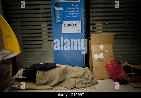 Barcelona, Catalonia, Spain. 27th Feb, 2013. File Image - Homeless man sleeping inside of an ATM in Barcelona on 26 February, 2013. © Jordi Boixareu/ZUMA Wire/Alamy Live News Stock Photo