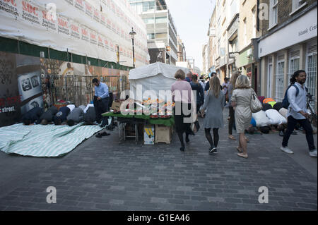 London, UK. 13th May 2016. Muslim office workers take part in Friday midday prayers in a central London street here 13th May 2016. Westminster Council decided this week to hand over control of Berwick Street market in Soho to a private operator. HUGH ALEXANDER/Alamy Live News Stock Photo