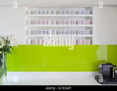 Modern Family home, Shepherds Bush, London. Close view of a kitchen countertop with a shelf of kitchen mugs arranged in perfect rows 'I Don't Have OCD'. Stock Photo