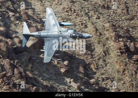 Marine Corps AV-8B Harrier II Jet Flying Low And At High Speed Through A Desert Canyon In California, USA. Stock Photo