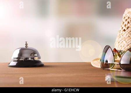 Objects of a tourist on the table in a hotel reception. Concept hotel, travel, room. Front view Stock Photo