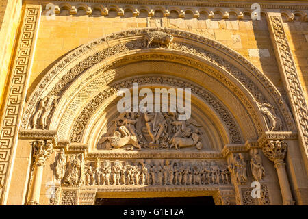 The tympanum of the great portal of the Saint-Fortunat church at the Benedictine abbey of Charlieu. Brionnais region Stock Photo